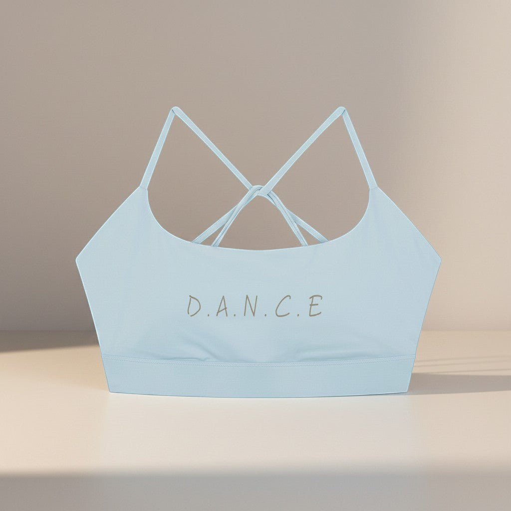 MONROE STORE light blue strappy criss-cross back sports bra with "D.A.N.C.E." graphic. Ideal for yoga and gym.