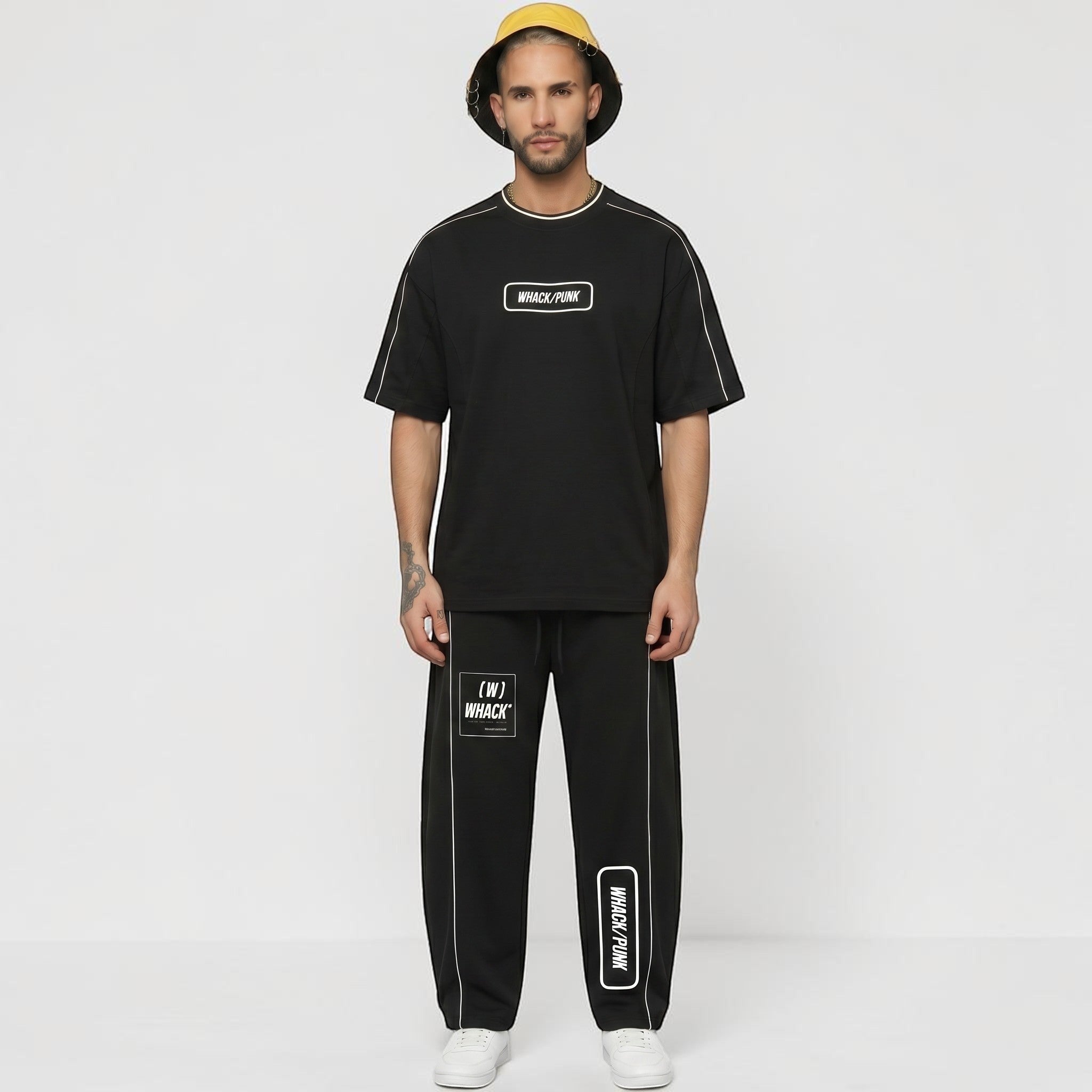 MONROE STORE unisex black cotton blend heavyweight barrel leg sweatpants with white piping and graphic print details.