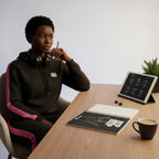 MONROE STORE black Hip Hop spiral notebook on a desk with a young woman in a black and pink hoodie