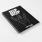 MONROE STORE black spiral notebook featuring a white Hip Hop hand gesture graphic and bold typography on the cover.