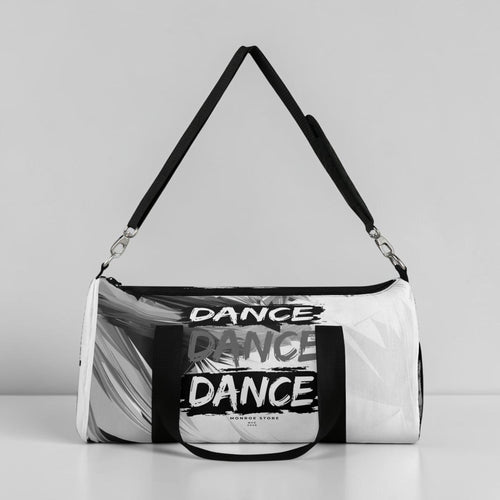 MONROE STORE bolsa de gimnasio negra y blanca con estampado abstracto y texto "DANCE" repetido. Cierre de cremallera doble y correa ajustable.