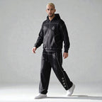 MONROE STORE conjunto de chándal negro de algodón y poliéster con cremallera completa y pantalones de pierna recta con detalles de costura y texto en japonés.