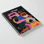 MONROE STORE cuaderno de espiral con diseño de figuras coloridas y vibrantes sobre fondo negro, ideal para artistas y escritores.