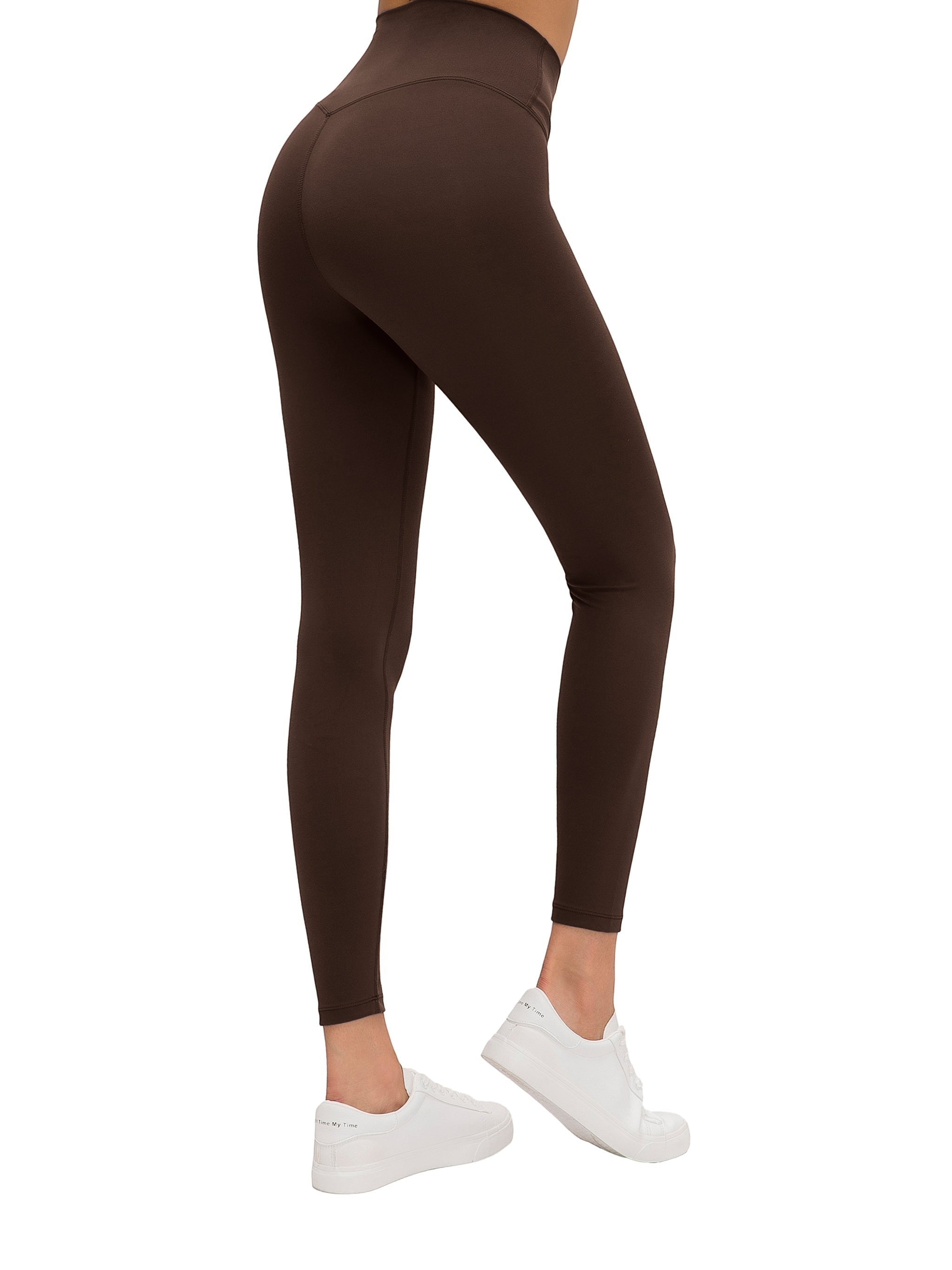 MONROE STORE high-waisted brown yoga leggings with a V-shaped seam on the back, made of a stretchy material.