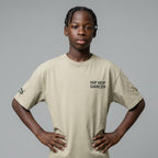 MONROE STORE oversized faded t-shirt in beige, made from 100% cotton with a relaxed fit and dropped shoulders. Features 'HIP HOP DANCER' text.