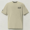 MONROE STORE oversized faded beige t-shirt with 'HIP HOP DANCER' graphic on back and sleeve details. 100% cotton.