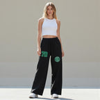 MONROE STORE pantalones de chándal negros de pierna ancha con cordón y detalle de parche "70" en verde.