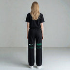 MONROE STORE pantalones de chándal negros de pierna ancha para mujer, 80% algodón, 20% poliéster, con cordón y estampado verde.