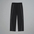 MONROE STORE Pantalones deportivos negros de pierna recta con cordón y detalles de rayas blancas reflectantes.