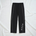 MONROE STORE Pantalones negros de algodón y poliéster con cordón, cintura media y rayas blancas laterales.