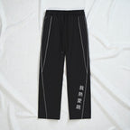 MONROE STORE Pantalones negros de algodón y poliéster con cordón, cintura media y rayas blancas laterales.