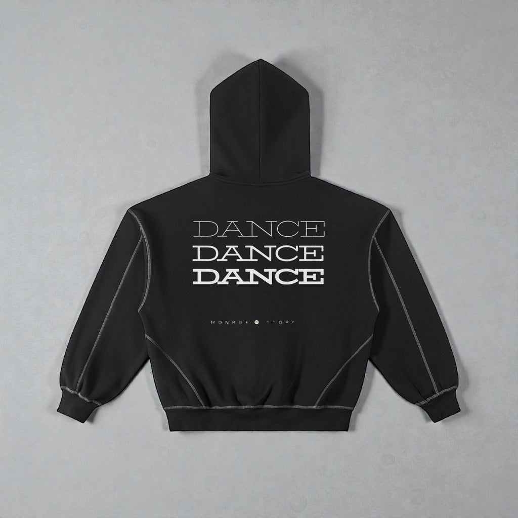 MONROE STORE sudadera negra con capucha y cremallera, con texto "DANCE" repetido y costuras de contraste.