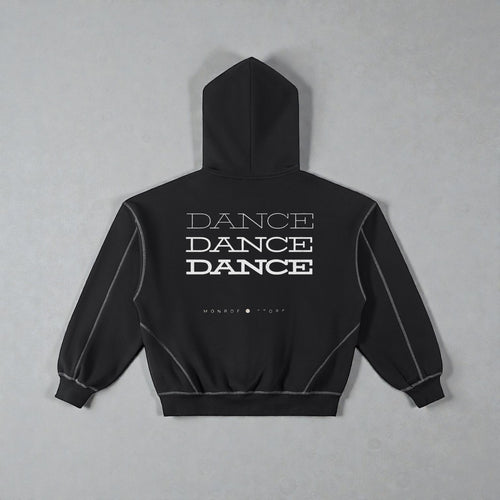 MONROE STORE sudadera negra con capucha y cremallera, con texto "DANCE" repetido y costuras de contraste.