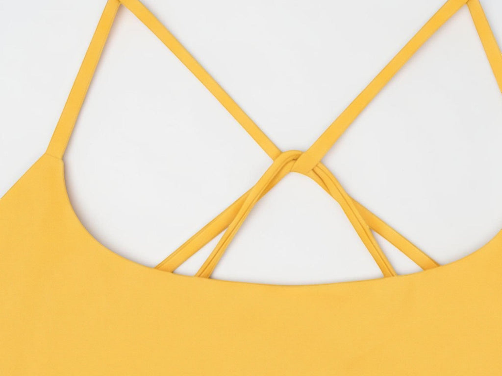 MONROE STORE yellow strappy criss cross yoga sports bra with a cropped fit.